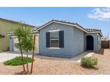 Charming home featuring stucco exterior, desert landscaping, and a welcoming front entrance at 36463 W San Alvarez Ave, Maricopa, AZ 85138