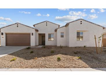 Charming single story home showing front elevation, garage and low maintenance desert landscaping at 37627 W Padilla St, Maricopa, AZ 85138