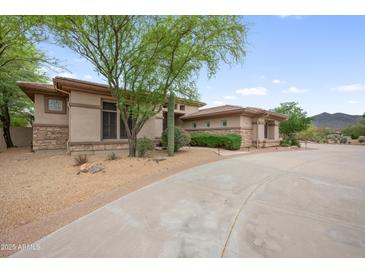Stunning single-story home featuring lush landscaping and a private driveway at 4684 E Coachwhip Rd, Cave Creek, AZ 85331