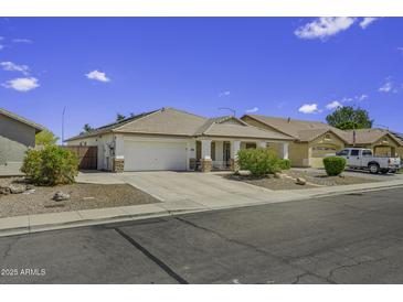 Charming single-story home featuring desert landscaping, tile roof, covered porch, and two-car garage at 7832 E Osage Ave, Mesa, AZ 85212