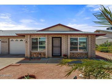 Charming single story home with a brick facade, large windows, and well-maintained landscaping at 9625 W Mountain View Rd # A, Peoria, AZ 85345