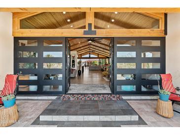 Inviting entrance with modern door, wood ceiling, and glimpses into the spacious living area at 11119 W Mountain View Rd, Sun City, AZ 85351