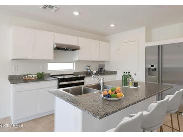 Bright kitchen features granite countertops, stainless appliances, and ample cabinet space at 1201 N 13Th St, Coolidge, AZ 85128