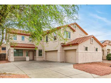 Charming two-story home with a three-car garage and a tile roof at 16215 W Durango St, Goodyear, AZ 85338