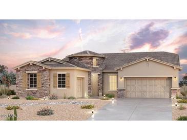 Charming single-story home featuring stone accents, a two-car garage, and low-maintenance desert landscaping at 20266 W Mulberry Dr, Buckeye, AZ 85396
