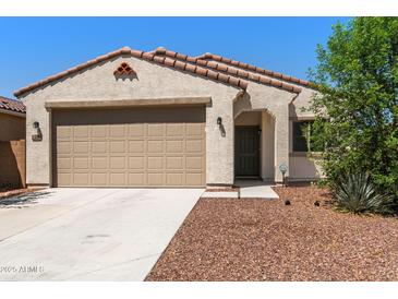 Charming single-story home with a two-car garage, neutral stucco, and a tile roof at 238 W Kona Dr, Casa Grande, AZ 85122