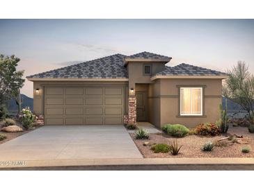 Inviting single-Gathering home showcasing a two-car garage, desert landscaping, and stone veneer accents at 25186 W Wier Ave, Buckeye, AZ 85326