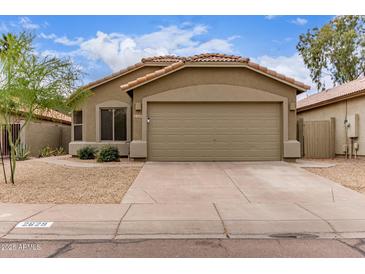 Charming single-story home with a tile roof, desert landscaping, and a spacious two-car garage at 2629 E Beverly Rd, Phoenix, AZ 85042