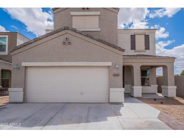 Two-story home featuring a two-car garage, covered front porch, and neutral-colored stucco exterior at 4205 W Maggie Dr, San Tan Valley, AZ 85144
