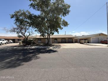 Charming single-story home featuring a well-maintained front yard and a welcoming facade at 8115 N 56Th Ave, Glendale, AZ 85302