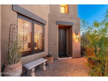 Inviting front entrance features desert landscaping and brick paver walkway at 9270 E Thompson Peak Pkwy # 367, Scottsdale, AZ 85255