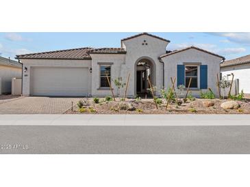 Charming single-story home with stucco exterior, landscaped yard, and inviting arched entryway at 12327 W Luxton Ln, Avondale, AZ 85323