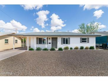 Charming home featuring a desert landscape, covered parking, and gray trim at 5328 E Yale St, Phoenix, AZ 85008