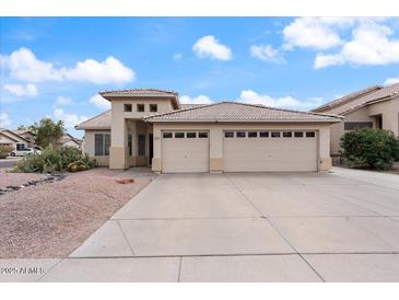 Charming single-story home showcasing a well-maintained front yard and an attached two-car garage at 1061 E Linda Ln, Gilbert, AZ 85234