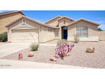 Charming single-story home with desert landscaping and a two-car garage on a sunny day at 13414 W Maui Ln, Surprise, AZ 85379