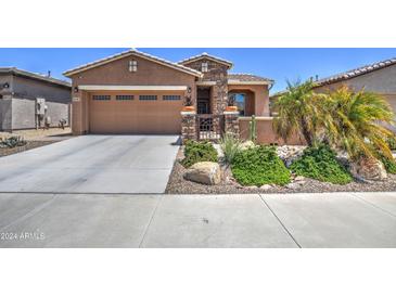 Charming single-Gathering home with a two-car garage, desert landscaping, and gated courtyard at 16781 S 181St Ln, Goodyear, AZ 85338