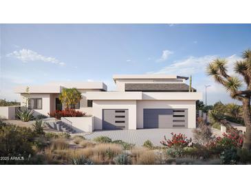 Stunning desert home with two-car garage and beautifully landscaped front yard, set against a bright blue sky at 17837 W Estes Way, Goodyear, AZ 85338