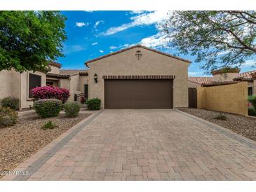 Charming home featuring a paved driveway and desert landscaping with colorful flowering shrubs at 1813 N Trowbridge --, Mesa, AZ 85207