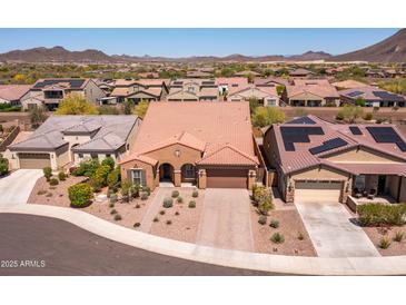 An aerial shot of a landscaped house featuring a tile roof, desert landscaping, and a two-car garage at 30876 N 128Th Dr, Peoria, AZ 85383