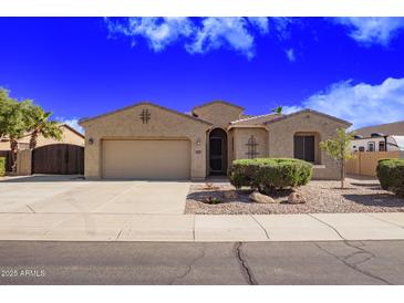 Charming single-story home with a two-car garage, desert landscaping, and neutral color palette at 40853 W Bravo Dr, Maricopa, AZ 85138