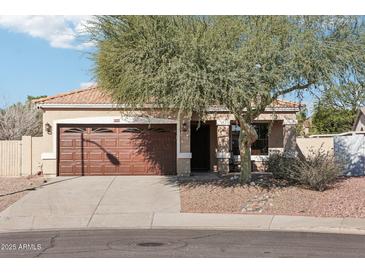 Charming single-story home features a two-car garage and mature landscaping at 6836 W Bronco Trl, Peoria, AZ 85383