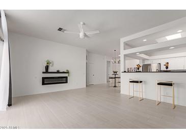 Spacious living room featuring a modern fireplace and open access to the kitchen at 7006 E Jensen St # 40, Mesa, AZ 85207