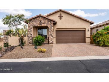 Charming home featuring a stone facade, a two-car garage, and desert landscaping for low maintenance at 8804 E Ivy St, Mesa, AZ 85207