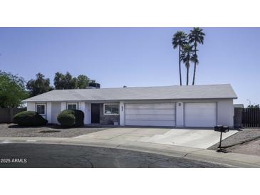 Charming single-story home featuring a three-car garage, low-maintenance landscaping, and mature palm trees at 1209 W Tulane Dr, Tempe, AZ 85283