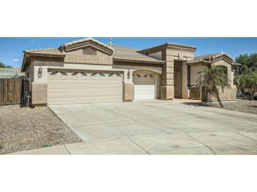 Home featuring a three car garage, neutral color scheme, and large concrete driveway at 15211 N 184Th Ct, Surprise, AZ 85388