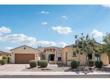 Inviting single-story home featuring a well-manicured front yard and a two-car garage, under a partly cloudy sky at 15849 W Alvarado Dr, Goodyear, AZ 85395