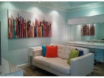 Cozy living room area with stylish sofa, modern art, and a bright, welcoming atmosphere at 1701 E Colter St # 280, Phoenix, AZ 85016