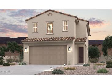 Charming two-story home with a tile roof, two-car garage, and desert landscaping at 17356 W Jessie Ln, Surprise, AZ 85387