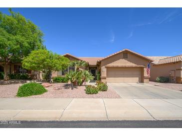 Charming single-story home with a well-maintained front yard and attached two-car garage at 17958 W Udall Dr, Surprise, AZ 85374
