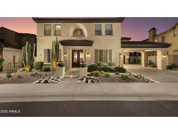 Elegant two-story home boasts desert landscaping, a porte-cochère, and a warm, inviting facade at 22406 N 36Th Way, Phoenix, AZ 85050