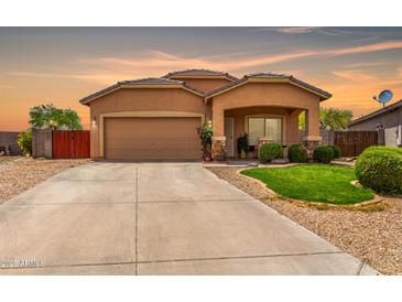 Charming single-story home with a two-car garage, covered porch, manicured lawn, and a spacious driveway in a desirable neighborhood at 36064 N Murray Grey Dr, San Tan Valley, AZ 85143