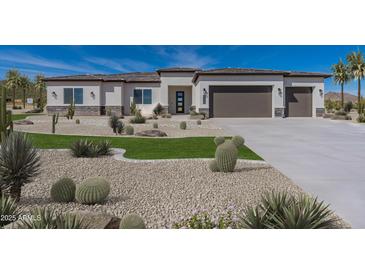 Beautiful desert home featuring a three-car garage, modern architecture, and desert landscaping at 6564 W Apex Ave, Queen Creek, AZ 85144