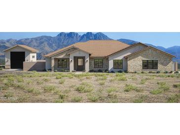 Charming single-story home boasting a tile roof, stone accents, and scenic mountain views at 14118 E Rancho Del Oro Ct, Scottsdale, AZ 85262