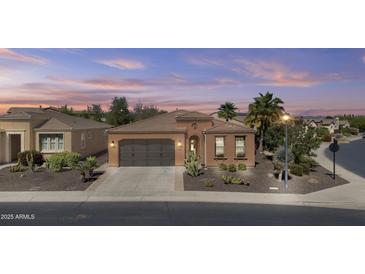 Charming single-story home with a well-maintained lawn, desert landscaping, and a two-car garage at 1588 E Sweet Citrus Dr, Queen Creek, AZ 85140