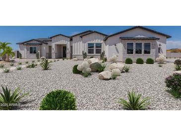 Stunning single-story home featuring low-maintenance desert landscaping, rocks, and cacti at 1845 N 103Rd St, Mesa, AZ 85207