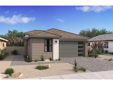 Charming single-story home featuring a modern garage door, desert landscaping, and a stone-accented facade at 20332 W Sells Dr, Buckeye, AZ 85396