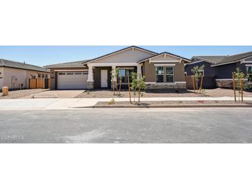 Charming single-story home showcasing a two-car garage, neutral stucco, and manicured landscaping at 22825 E Alyssa Rd, Queen Creek, AZ 85142