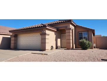 Charming single-story home with a well-maintained front yard and a two-car garage at 2397 E Winchester Pl, Chandler, AZ 85286
