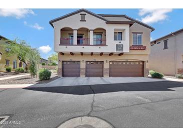 Three-story home with three-car garage, balcony, and desert landscaping at 2725 E Mine Creek Rd # 2058, Phoenix, AZ 85024