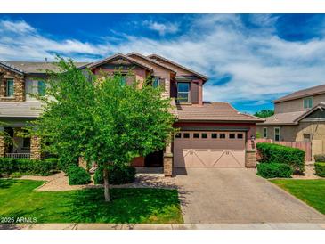 Charming two-story home featuring manicured front yard and a two car garage with a brick driveway at 3072 E Appaloosa Rd, Gilbert, AZ 85296
