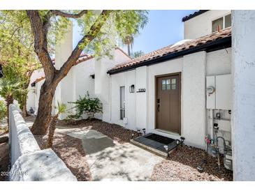 Charming home exterior with a brown front door, a lovely tree, and a well-maintained yard at 5350 N 3Rd Ave, Phoenix, AZ 85013