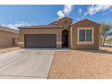 Charming single-story home with a two-car garage and low maintenance desert landscaping at 1239 E Elaine St, Casa Grande, AZ 85122
