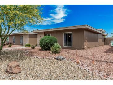 Charming single-story home with desert landscaping, rock ground cover, and a beautiful blue sky at 13821 N Thunderbird Blvd, Sun City, AZ 85351