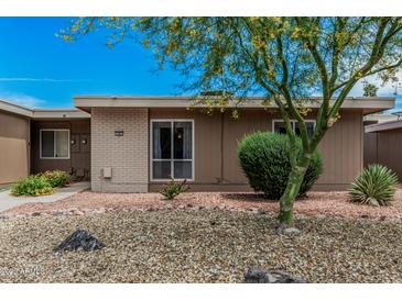Cozy single-story home featuring desert landscaping, rock ground cover, and a healthy green tree at 13821 N Thunderbird Blvd, Sun City, AZ 85351