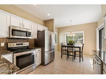 Kitchen featuring stainless steel appliances, granite countertops, and an eat-in area at 13850 N Mirage Heights Ct # 201, Fountain Hills, AZ 85268