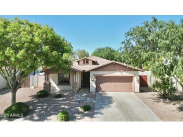 Charming single-story home featuring a well-manicured front yard, desert landscaping, and attached two-car garage at 1516 E Azalea Dr, Gilbert, AZ 85298